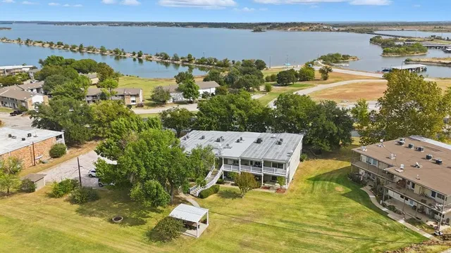 an aerial view of residential houses with yard