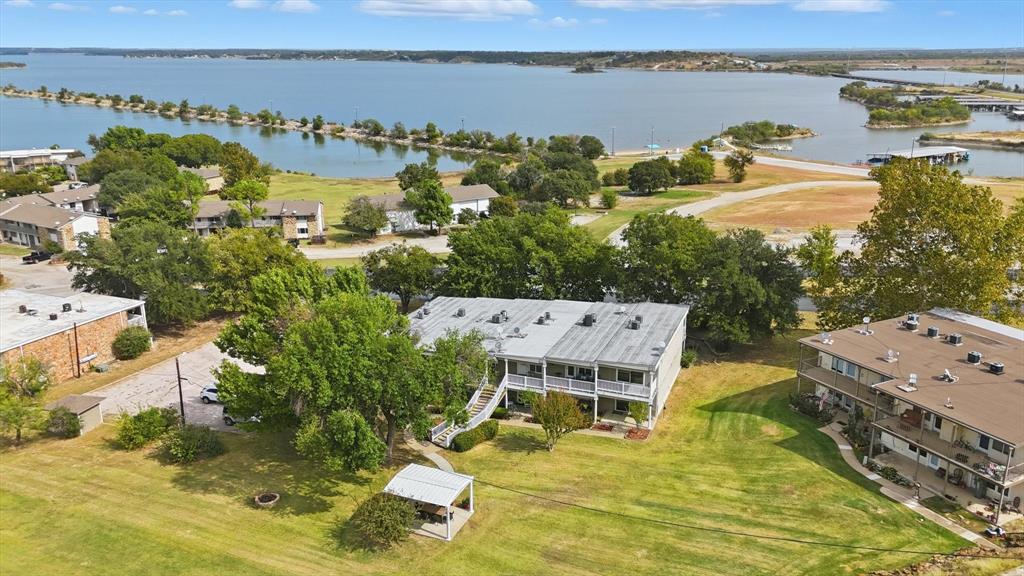 81 Runaway Bay Drive, Unit 220 Runaway Bay, TX 76426 - Photo 21 of 32 an aerial view of a residential building with outdoor space and lake view