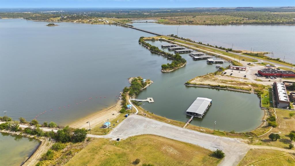 81 Runaway Bay Drive, Unit 220 Runaway Bay, TX 76426 - Photo 29 of 32 a view of a lake with table and chairs