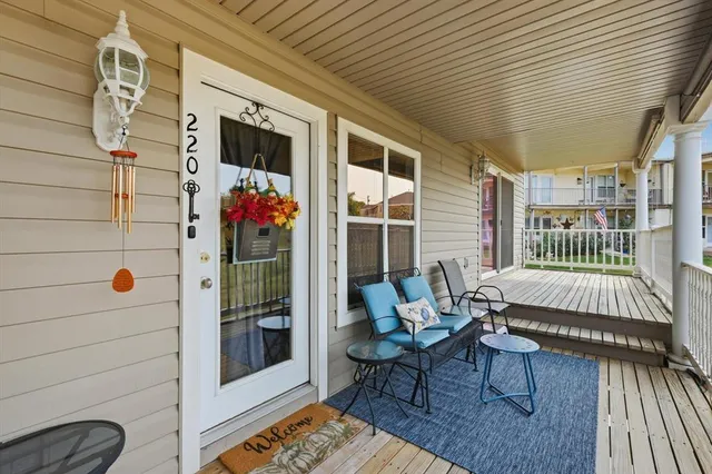a balcony with furniture and a potted plant
