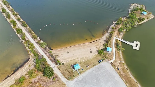 a view of a lake with table and chairs