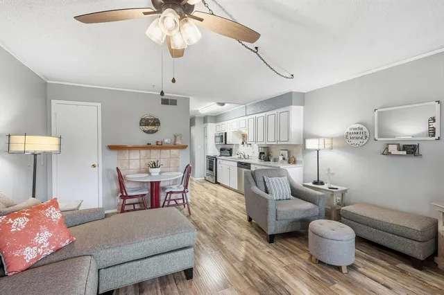 a living room with furniture and a chandelier