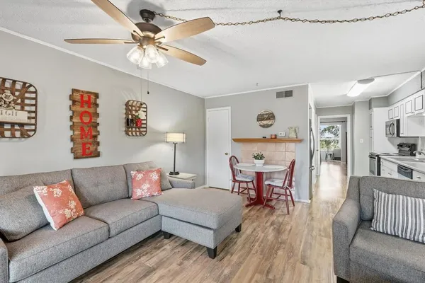 a living room with furniture and wooden floor