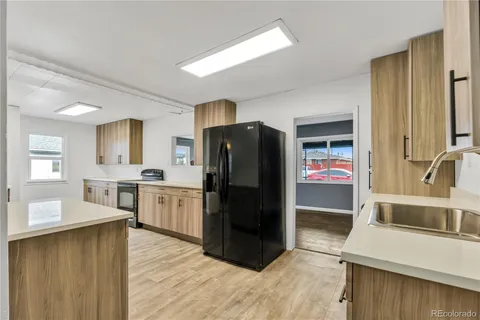 a kitchen with a refrigerator sink and stove