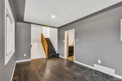 an empty room with furniture and stairs
