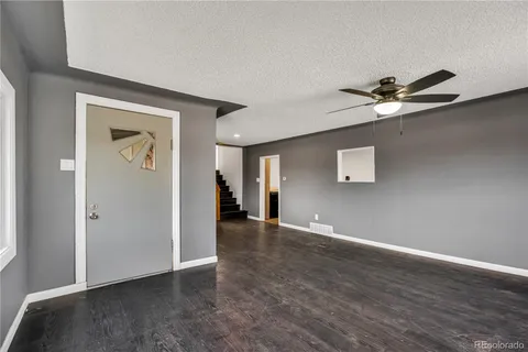 an empty room with fan and a ceiling fan