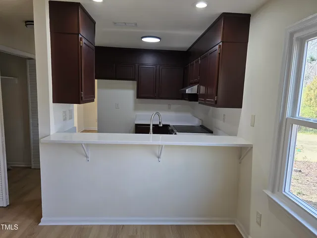 a view of kitchen with stainless steel appliances a refrigerator and a sink