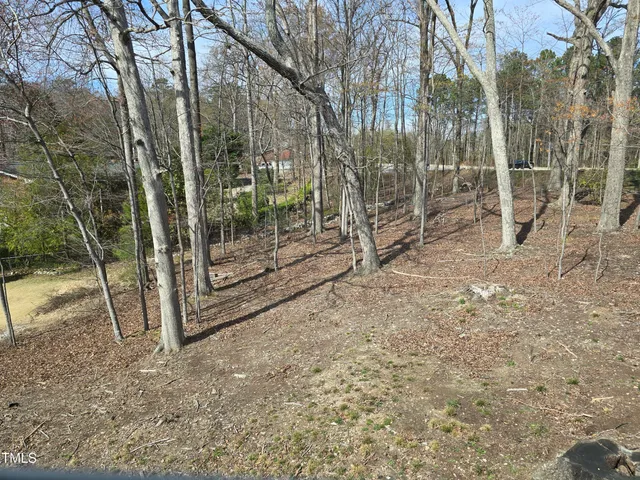 a view of a house with a yard and pathway