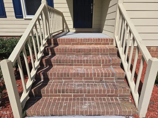 a view of wooden staircase and white walls
