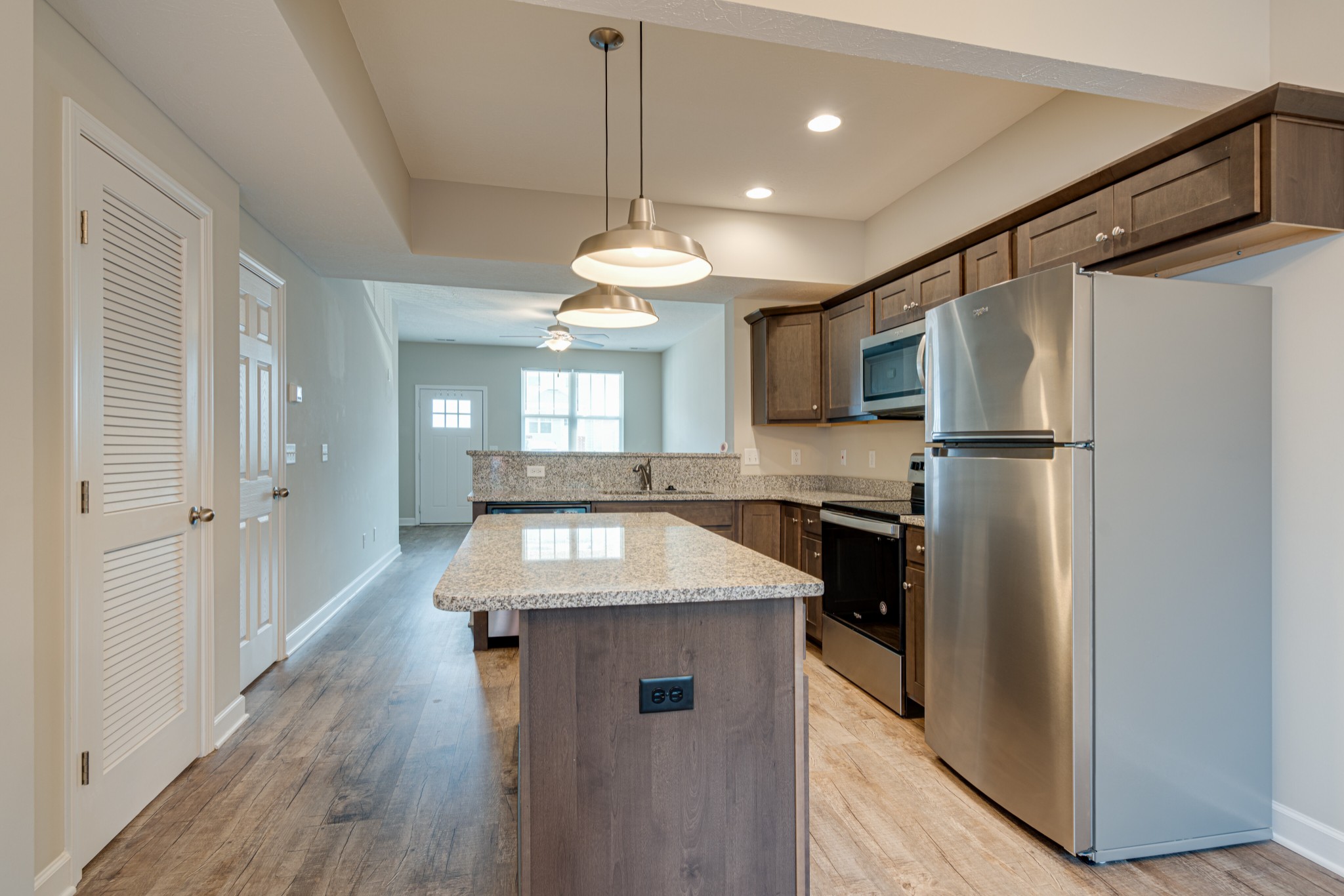 1382 Rural Hill Road, Unit 384 Antioch, TN 37013 - Photo 10 of 28 a kitchen with stainless steel appliances granite countertop a refrigerator a sink dishwasher a stove and a dining table with wooden floor