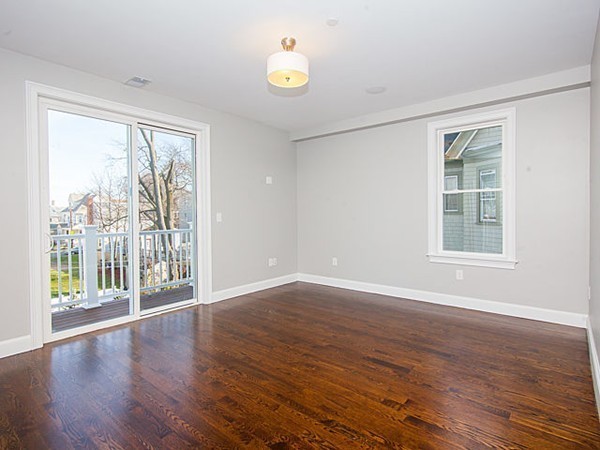 884 Adams Street, Unit 4 Boston, MA 02124 - Photo 11 of 27 a view of an empty room with wooden floor and a window