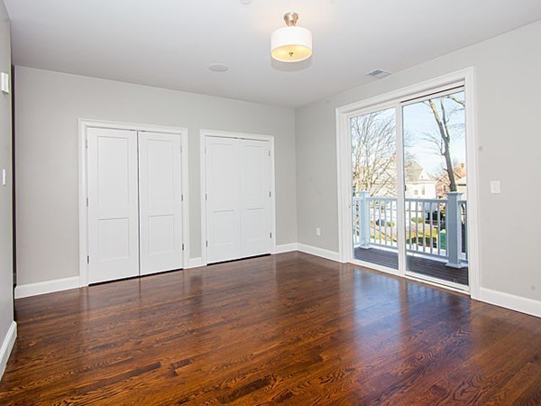 884 Adams Street, Unit 4 Boston, MA 02124 - Photo 12 of 27 a view of an empty room with wooden floor and a window