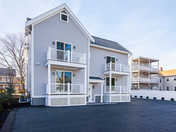 884 Adams Street, Unit 4 Boston, MA 02124 - Photo 19 of 27 a front view of a house with a yard