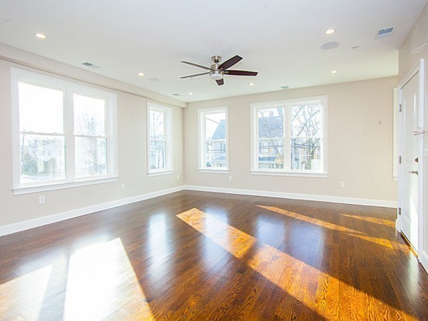 884 Adams Street, Unit 4 Boston, MA 02124 - Photo 3 of 27 a view of an empty room with wooden floor and a window