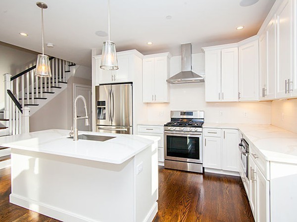 884 Adams Street, Unit 4 Boston, MA 02124 - Photo 5 of 27 a kitchen with stainless steel appliances granite countertop a sink stove and refrigerator