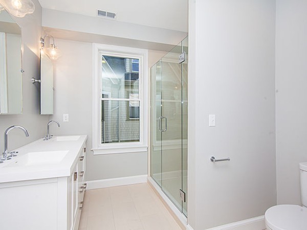 884 Adams Street, Unit 4 Boston, MA 02124 - Photo 6 of 27 a bathroom with a sink a toilet and shower