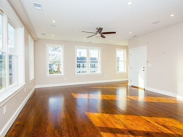 884 Adams Street, Unit 4 Boston, MA 02124 - Photo 7 of 27 a view of empty room with wooden floor and fan