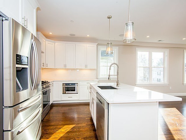 884 Adams Street, Unit 4 Boston, MA 02124 - Photo 9 of 27 a kitchen with stainless steel appliances granite countertop a stove a sink and a refrigerator