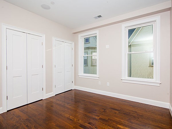 884 Adams Street, Unit 4 Boston, MA 02124 - Photo 10 of 27 a view of an empty room with wooden floor and a window