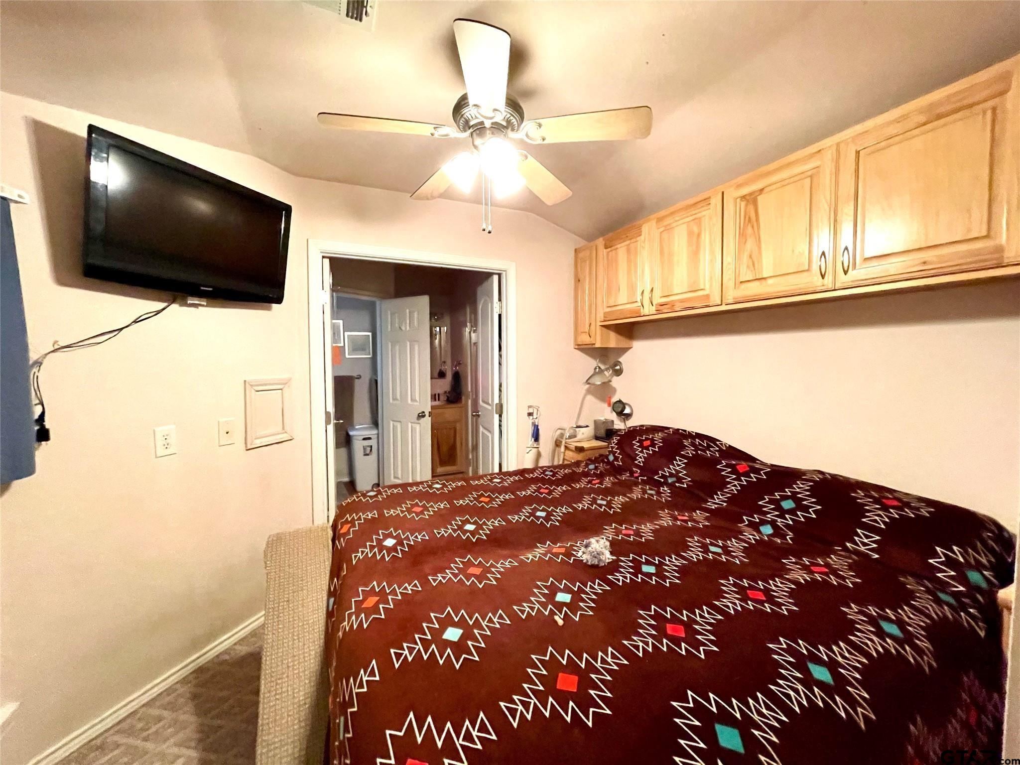 6435 FM 17 Yantis, TX 75497 - Photo 16 of 23 a bedroom with a bed and a flat screen tv