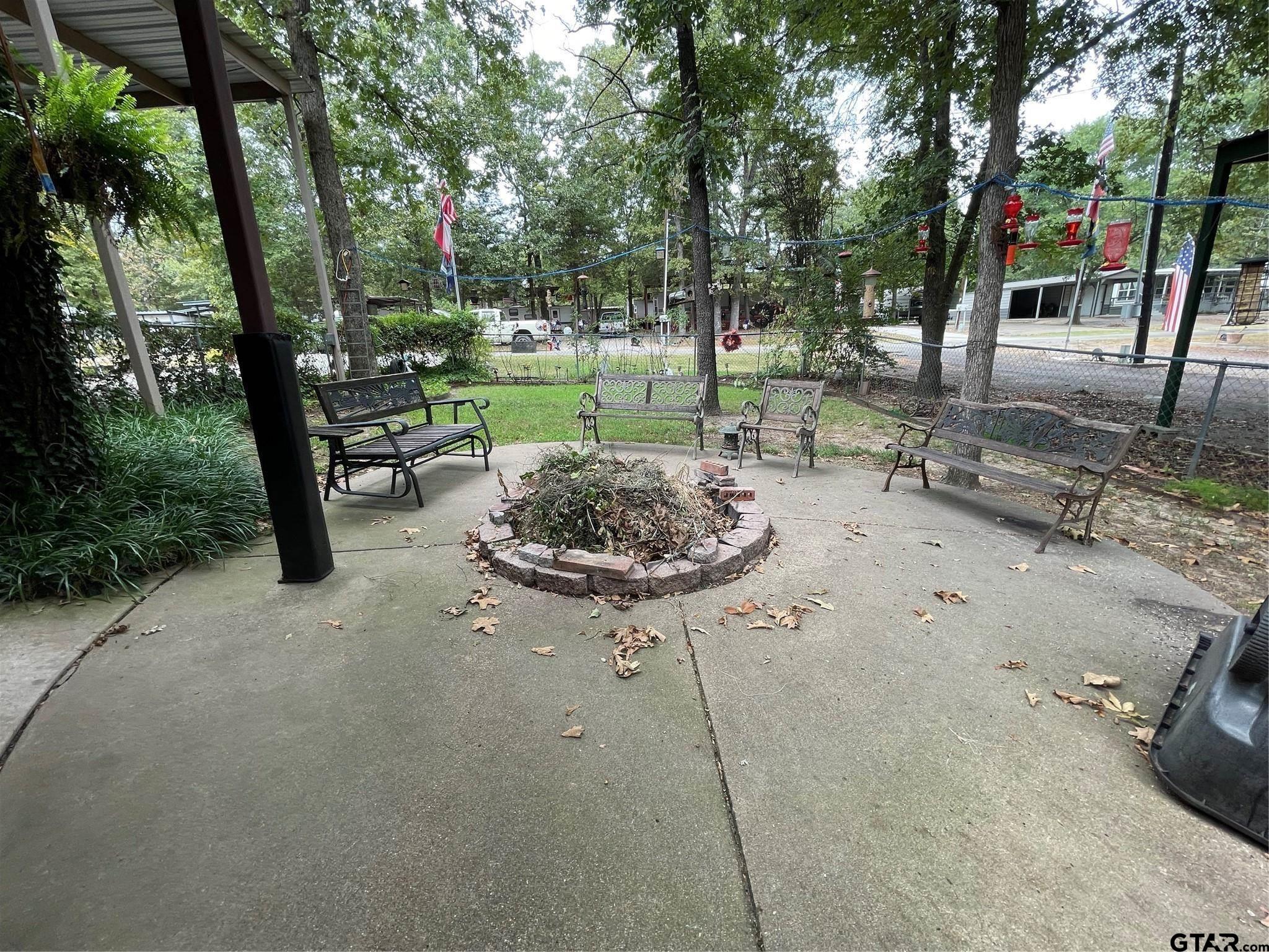 6435 FM 17 Yantis, TX 75497 - Photo 22 of 23 a view of a backyard with table and chairs potted plants and large tree