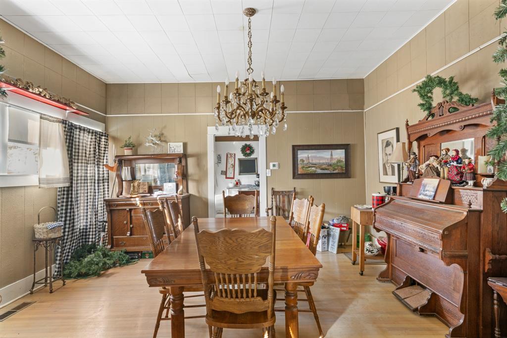 308 Race Street Baird, TX 79504 - Photo 13 of 27 Dining area featuring a chandelier and wood finished floors