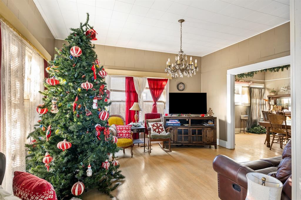 308 Race Street Baird, TX 79504 - Photo 16 of 27 Living room featuring a chandelier and wood-type flooring