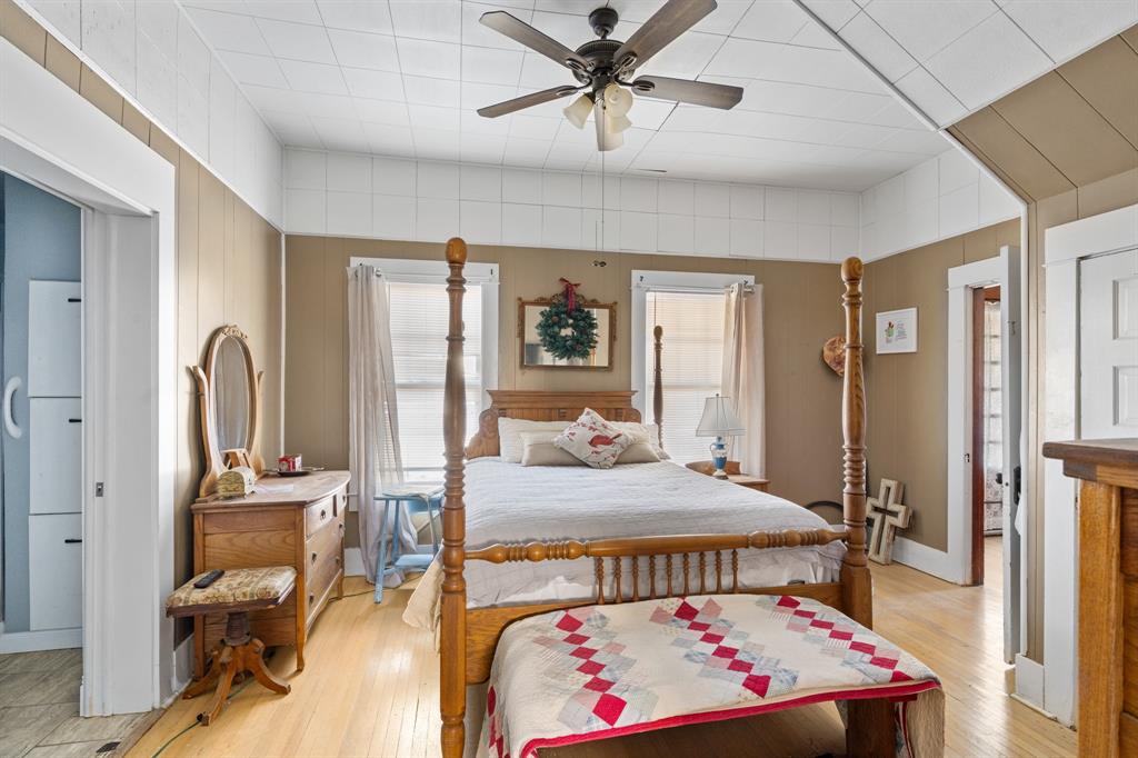 308 Race Street Baird, TX 79504 - Photo 17 of 27 Bedroom with light wood-style flooring, ensuite bathroom, and a ceiling fan