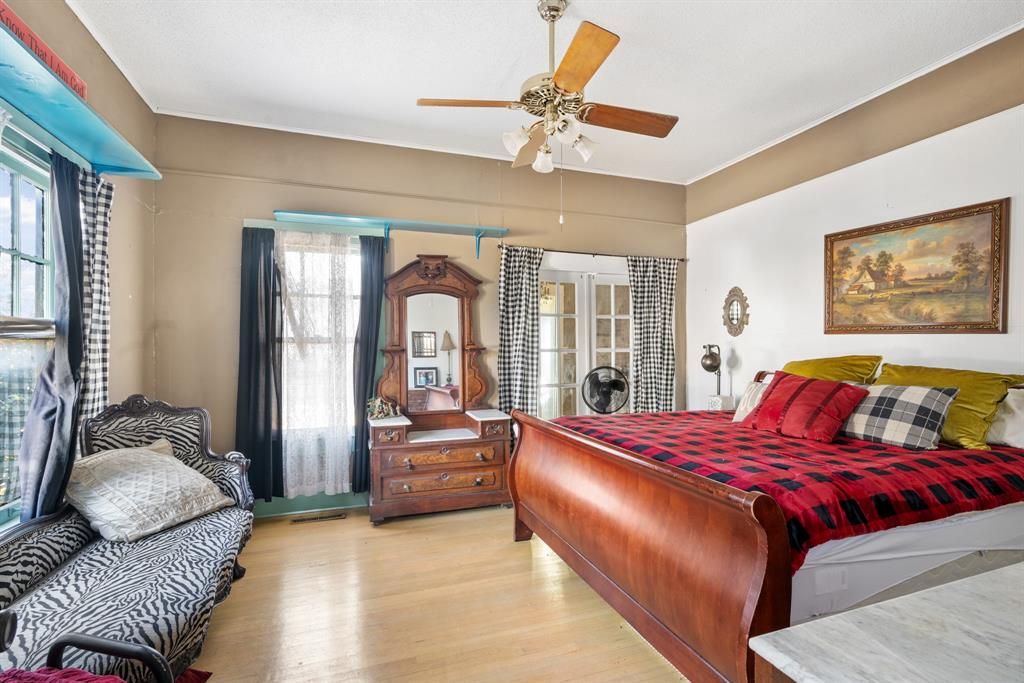 308 Race Street Baird, TX 79504 - Photo 19 of 27 Bedroom with crown molding, multiple windows, light wood-type flooring, and a ceiling fan