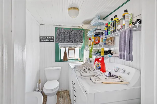 a bedroom with a large bed couch and a window