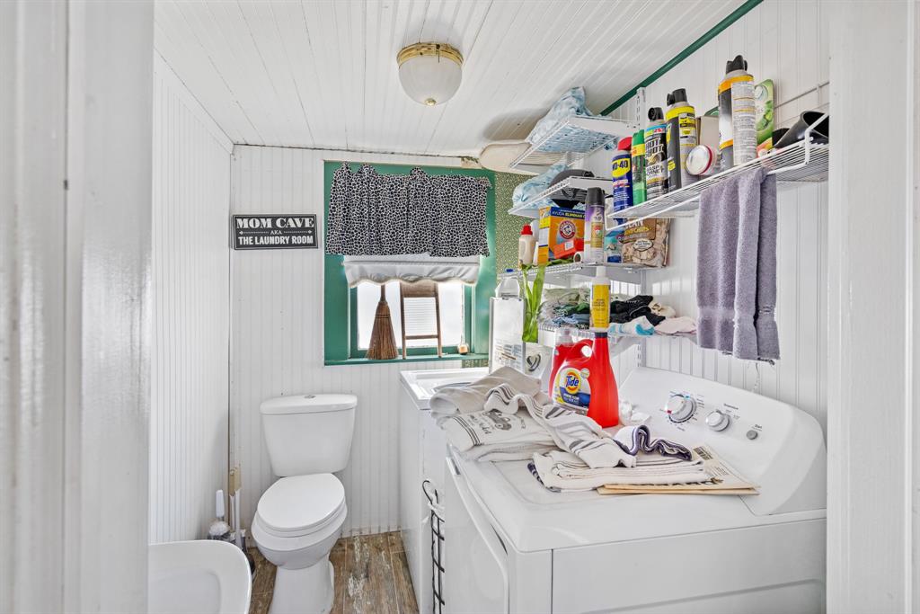308 Race Street Baird, TX 79504 - Photo 20 of 27 Bathroom with washing machine and dryer, light wood-style floors, and vanity