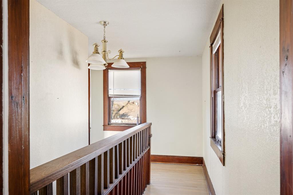 308 Race Street Baird, TX 79504 - Photo 25 of 27 Hall with a chandelier and light wood finished floors
