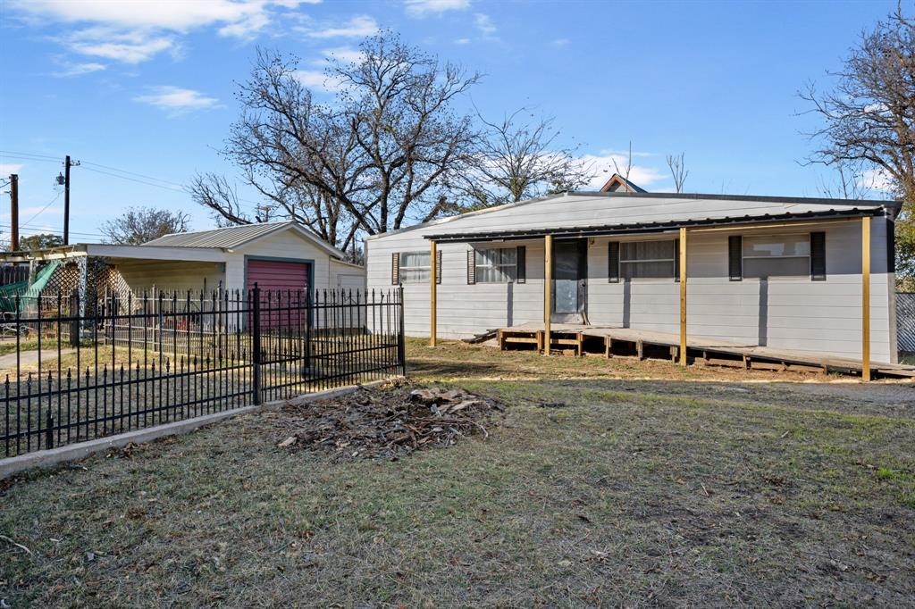 308 Race Street Baird, TX 79504 - Photo 6 of 27 View of front of property featuring an outdoor structure, covered porch, a detached garage, and a metal roof