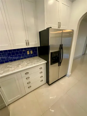a kitchen with stainless steel appliances a refrigerator and cabinets