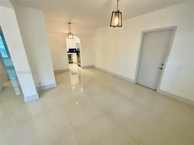 en empty room with wooden floor and windows