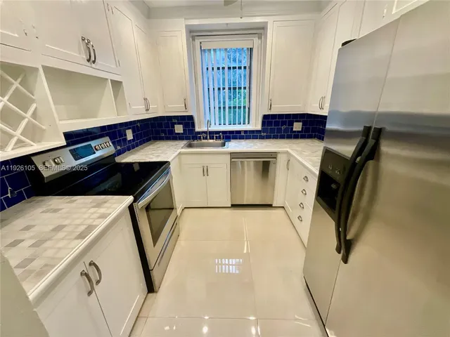 a kitchen with a sink a stove and cabinets