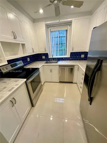 a kitchen with a refrigerator and window