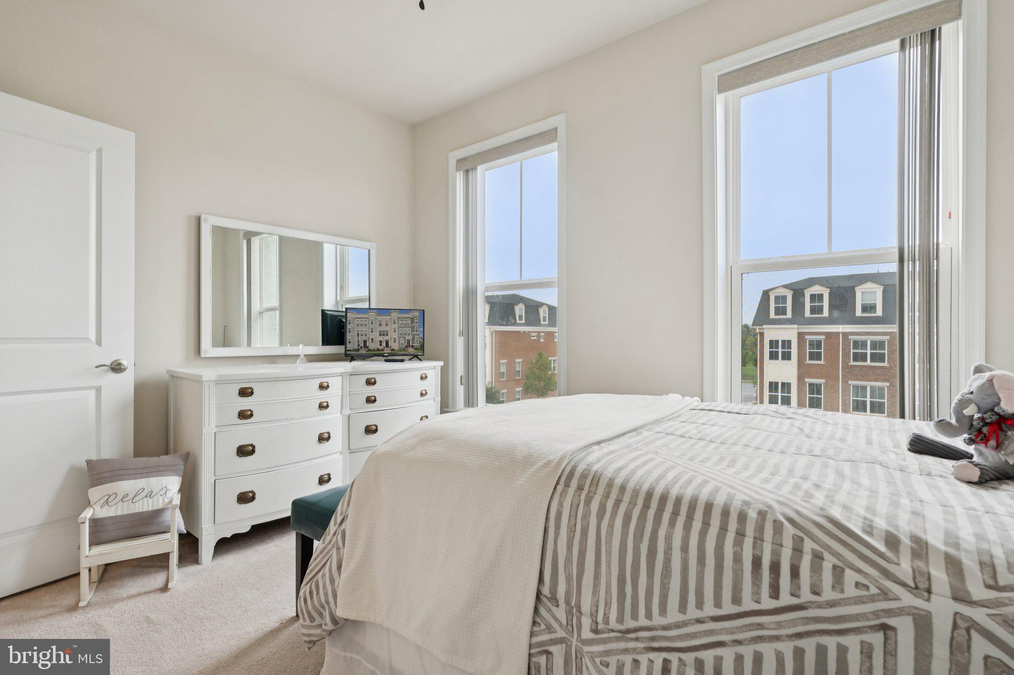 969 Holden Road Frederick, MD 21701 - Photo 21 of 35 a bedroom with a bed a mirror and a window