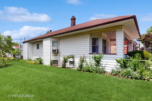 a front view of a house with a garden