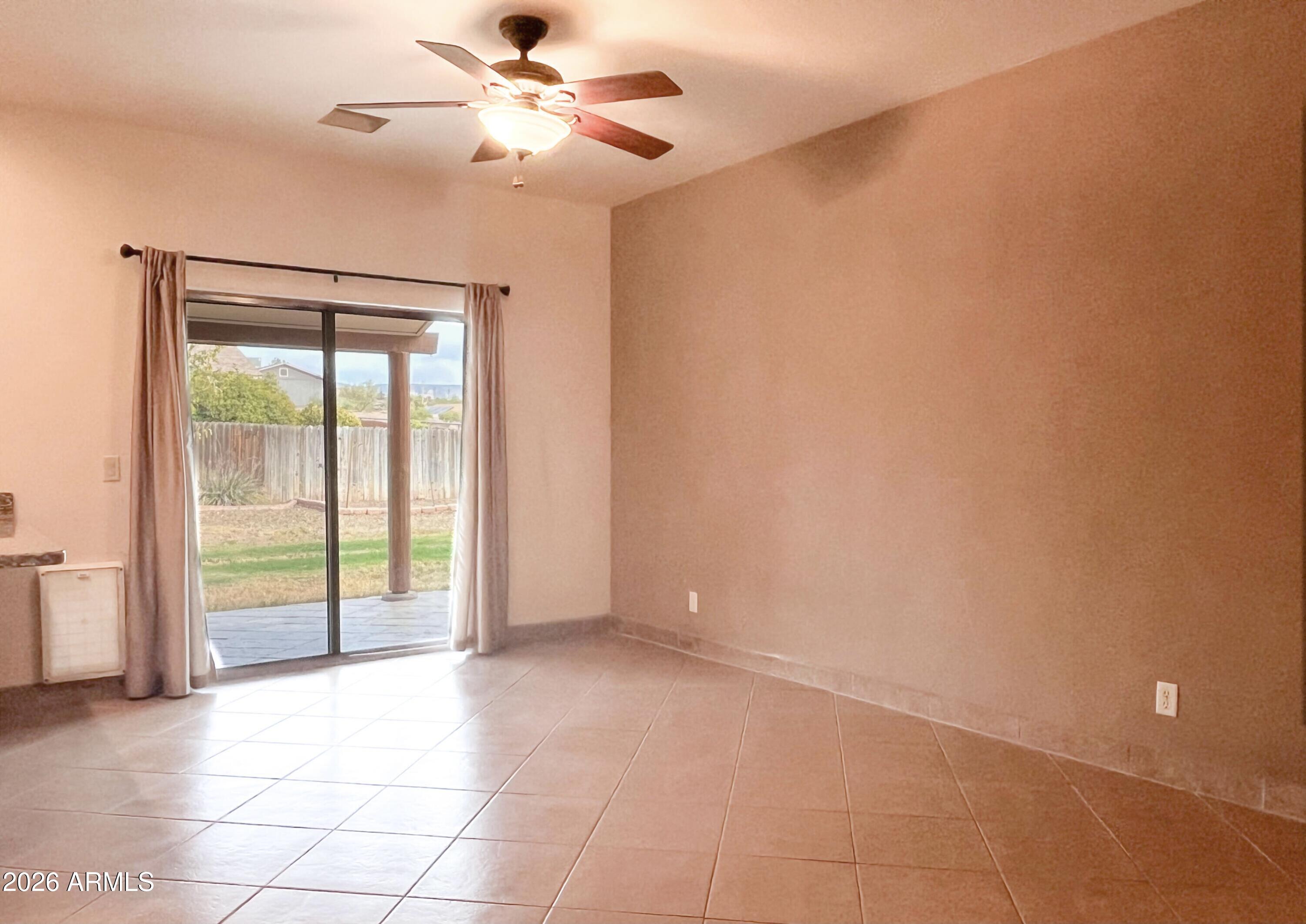 5655 North Laura Lane Rimrock, AZ 86335 - Photo 12 of 37 en empty room with windows and ceiling fan