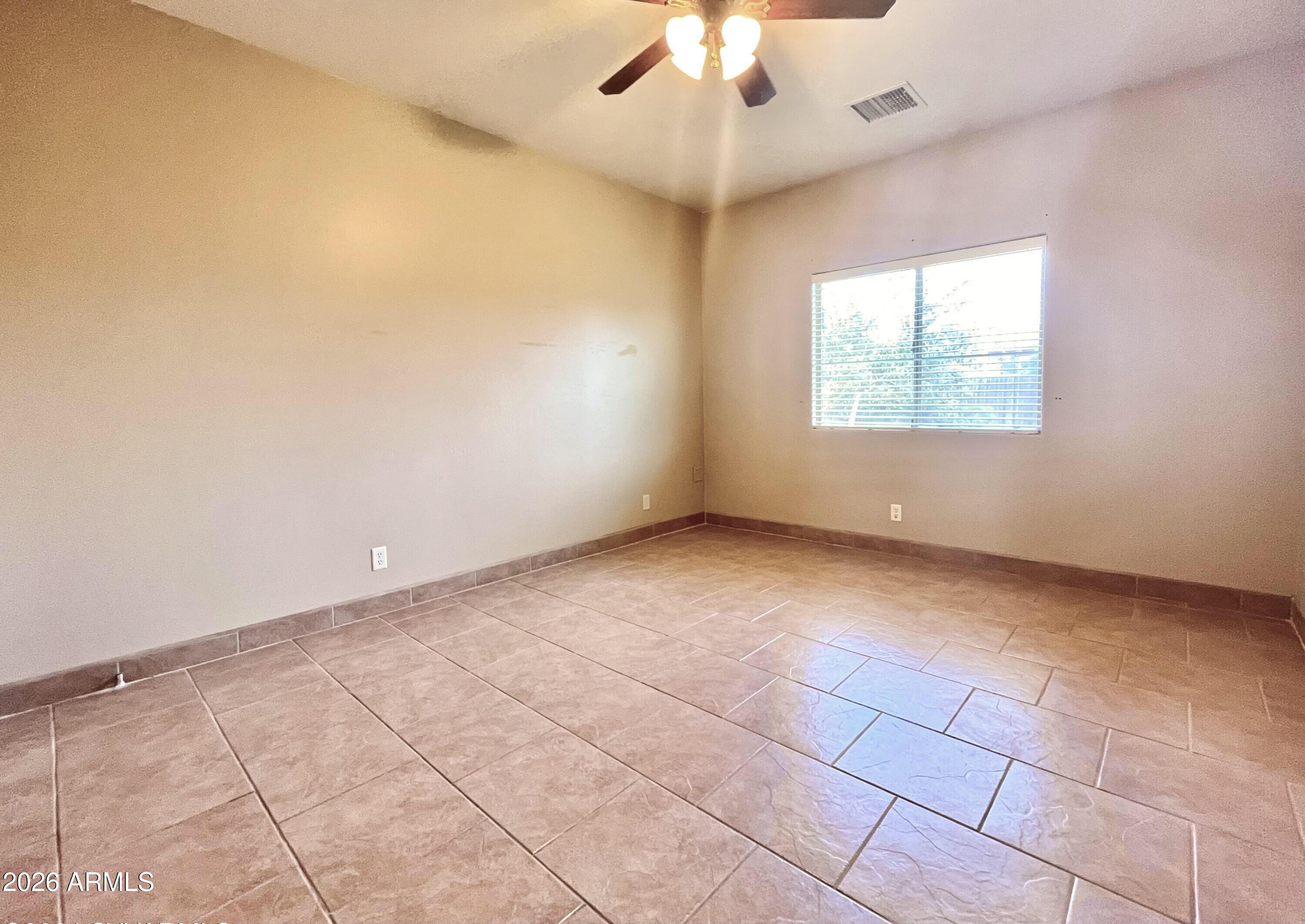 5655 North Laura Lane Rimrock, AZ 86335 - Photo 13 of 37 an empty room with a ceiling fan and window