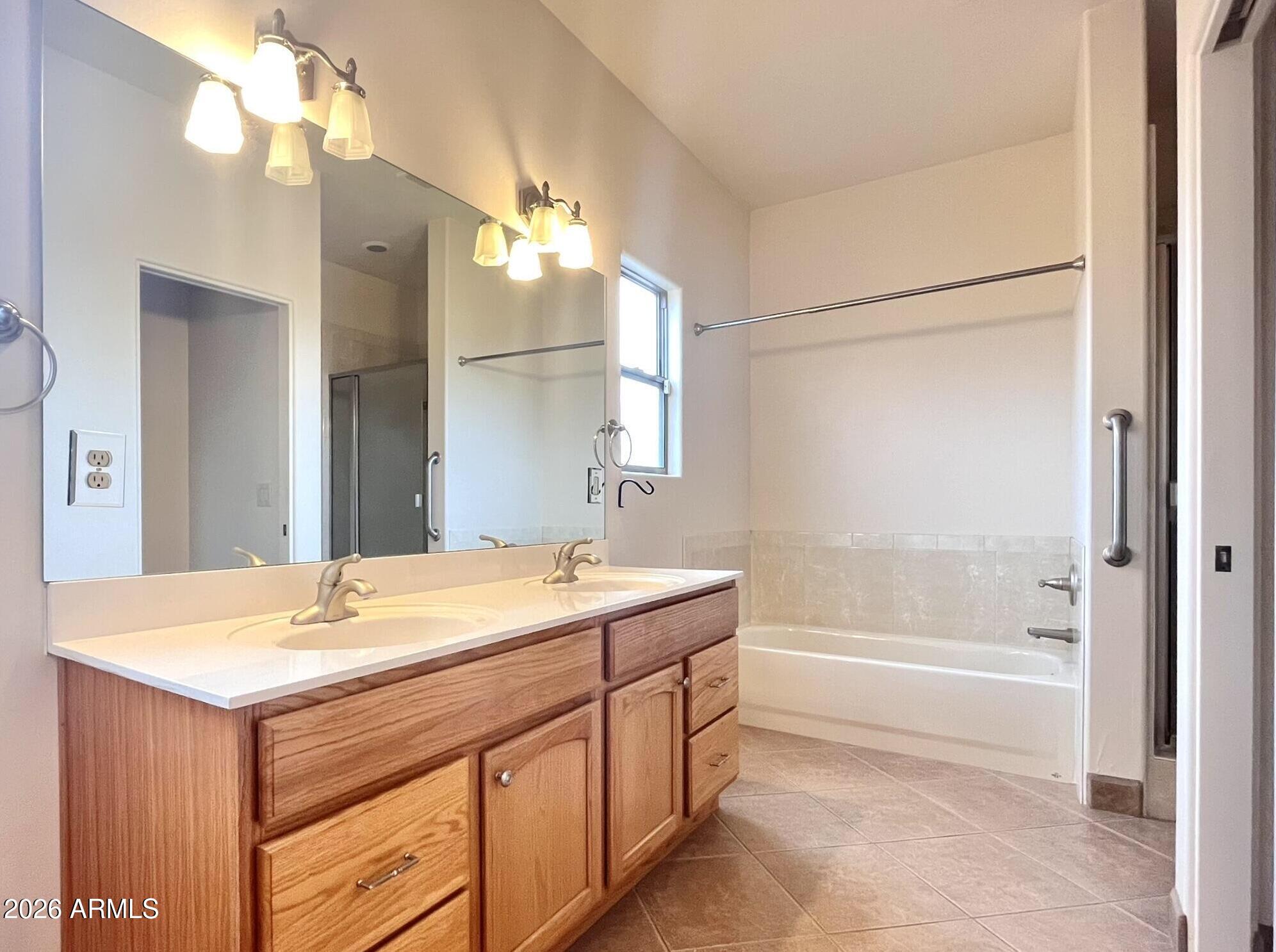 5655 North Laura Lane Rimrock, AZ 86335 - Photo 16 of 37 a bathroom with a sink a tub and a mirror