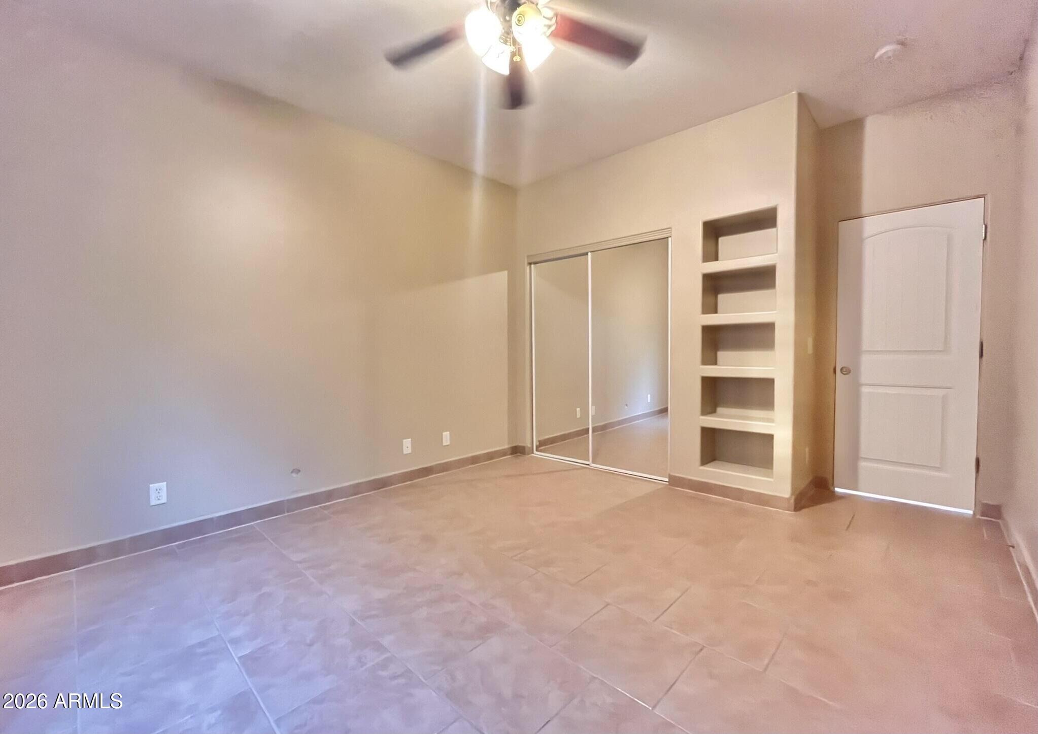5655 North Laura Lane Rimrock, AZ 86335 - Photo 25 of 37 an empty room with closet and a ceiling fan