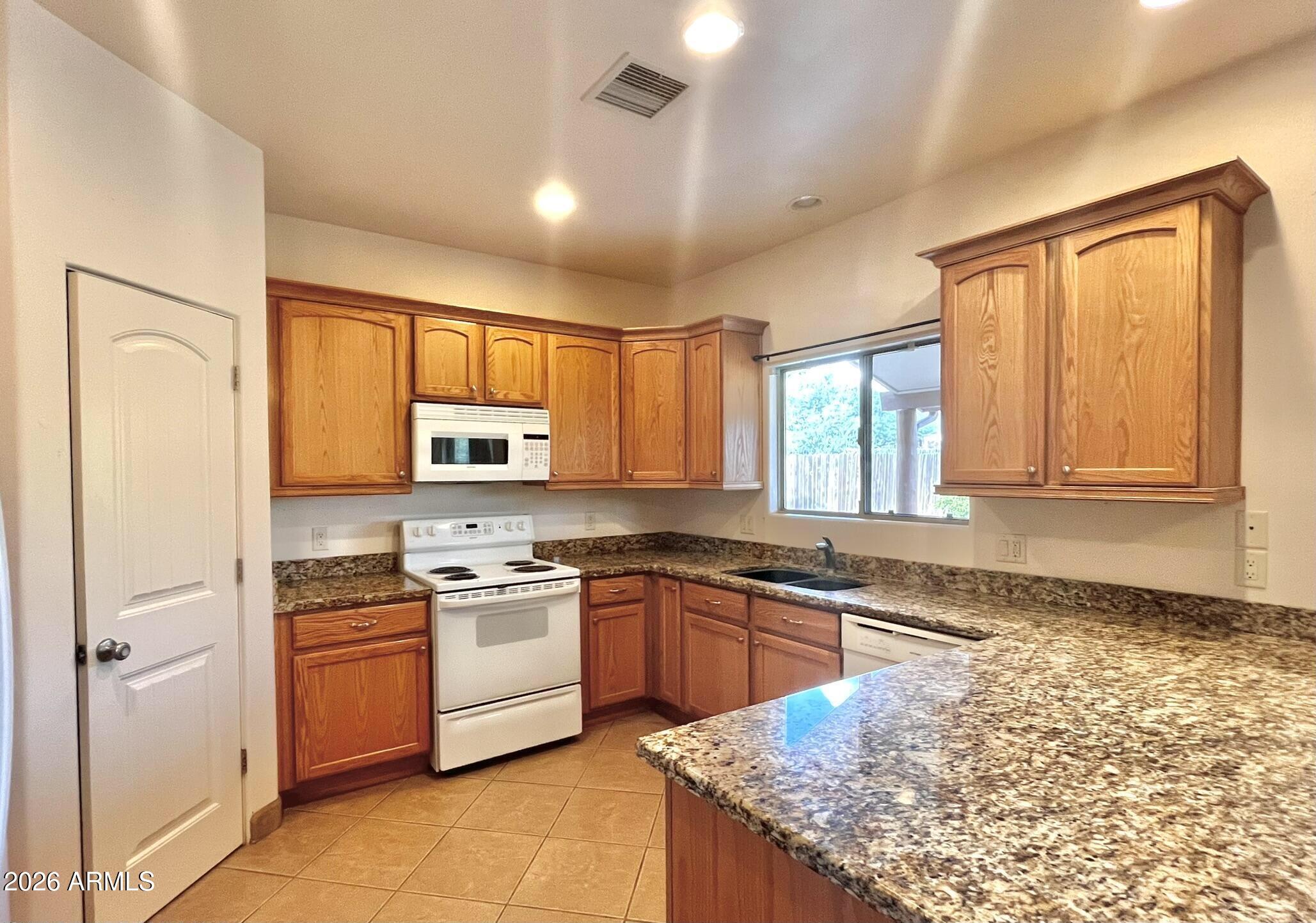 5655 North Laura Lane Rimrock, AZ 86335 - Photo 6 of 37 a kitchen with stainless steel appliances granite countertop a stove sink and cabinets