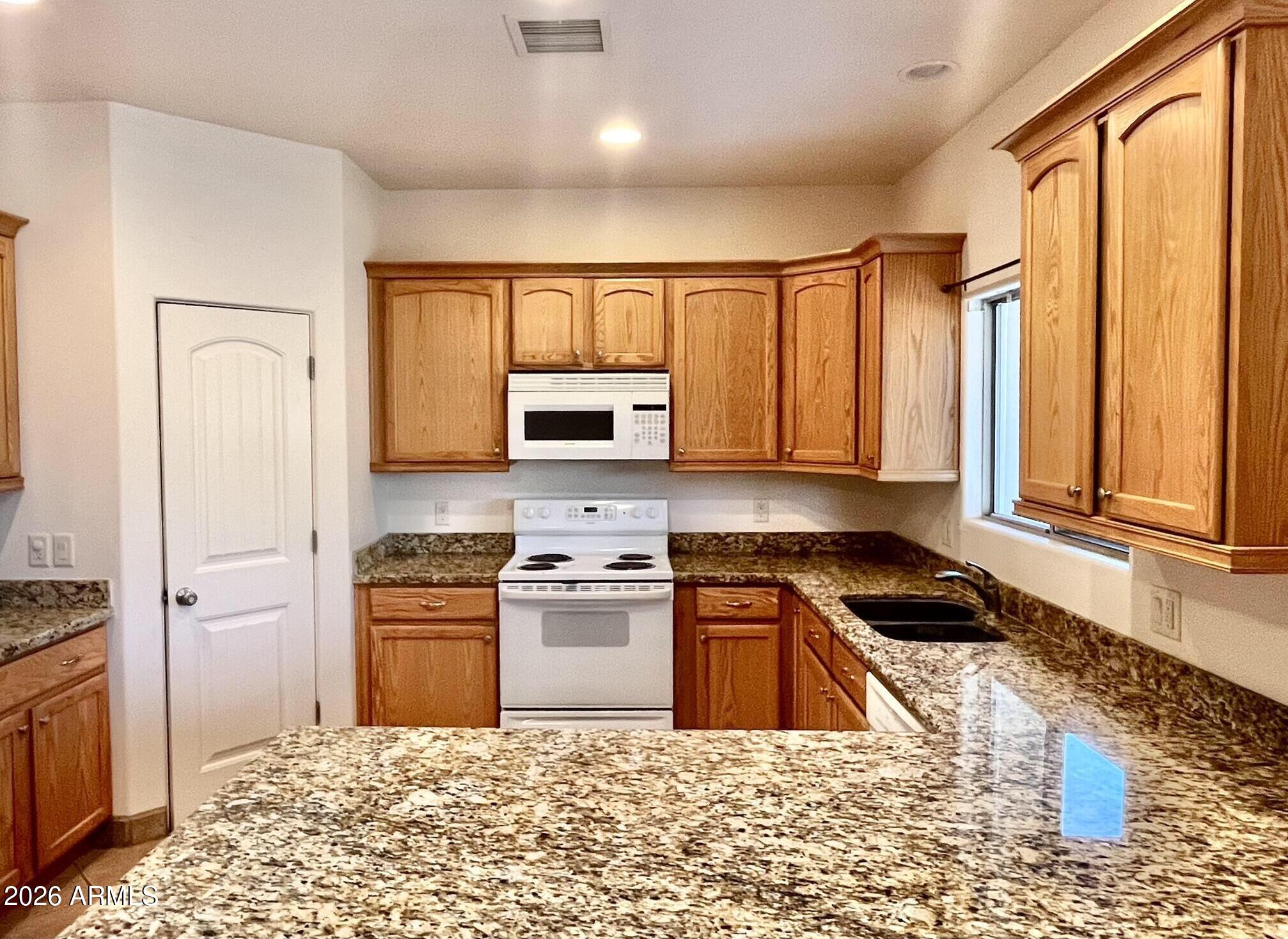 5655 North Laura Lane Rimrock, AZ 86335 - Photo 7 of 37 a kitchen with stainless steel appliances granite countertop a stove a sink and a refrigerator