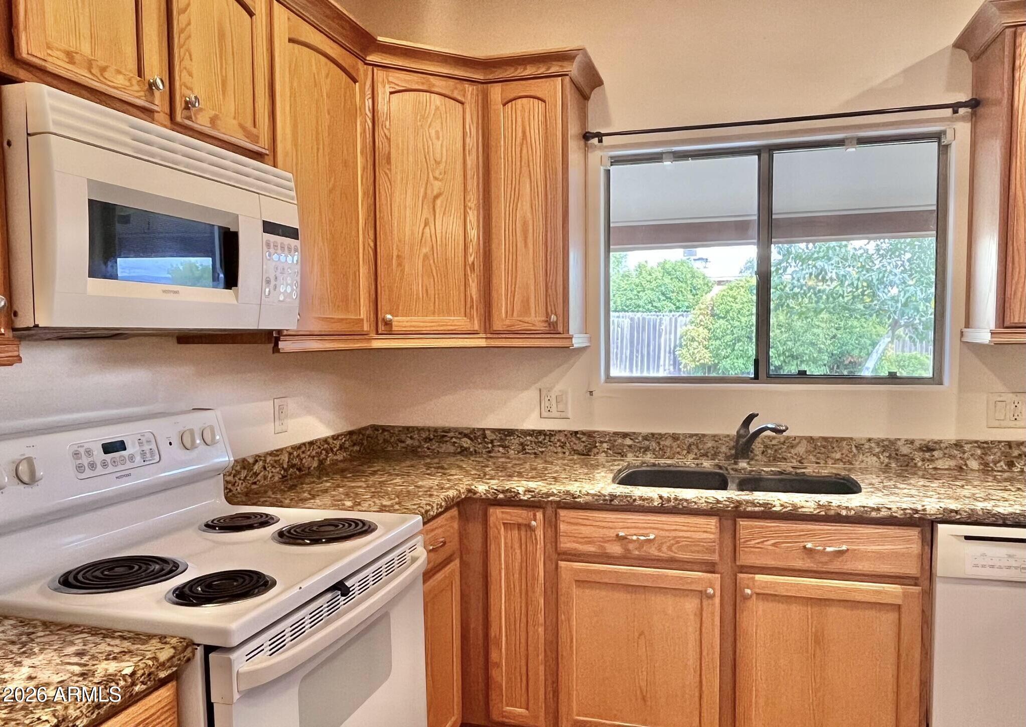 5655 North Laura Lane Rimrock, AZ 86335 - Photo 9 of 37 a kitchen with stainless steel appliances granite countertop a sink stove and cabinets