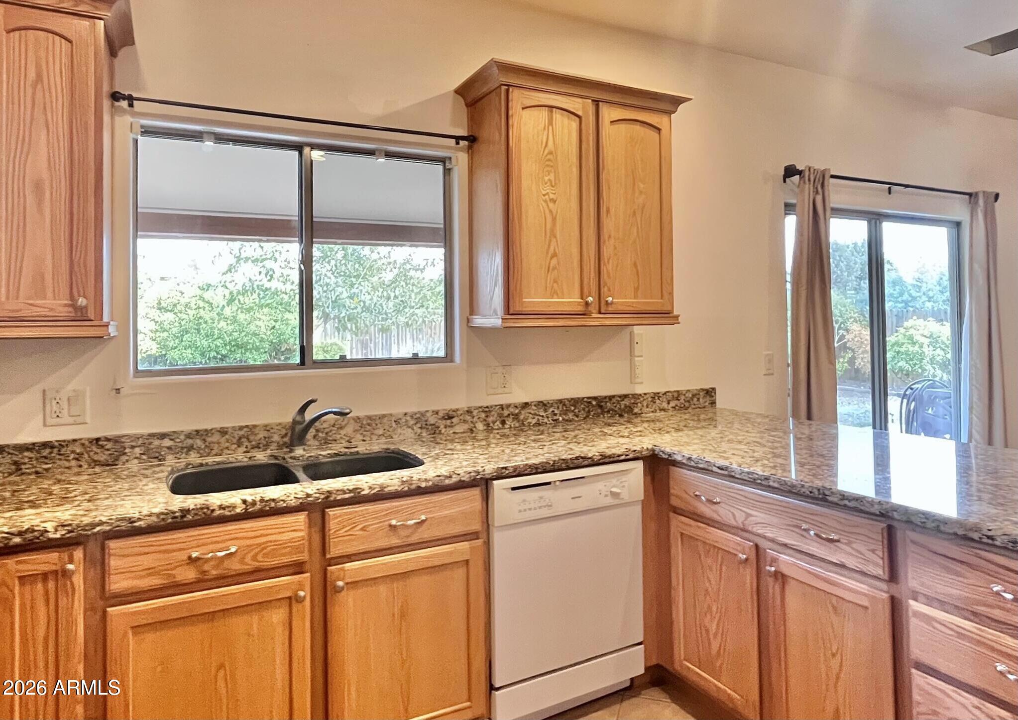5655 North Laura Lane Rimrock, AZ 86335 - Photo 10 of 37 a kitchen with granite countertop a sink and a window