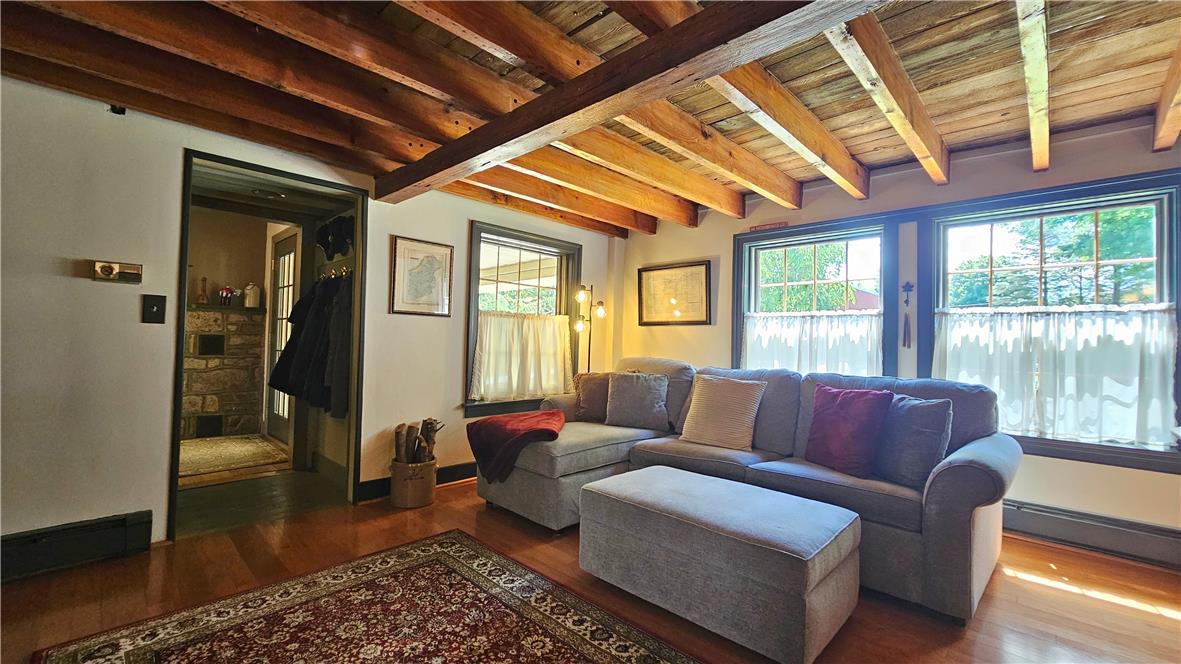 585 Buttermilk Road Hellertown, PA 18055 - Photo 15 of 82 Rich hardwood flooring and exposed beam ceilings create a warm, inviting living space.