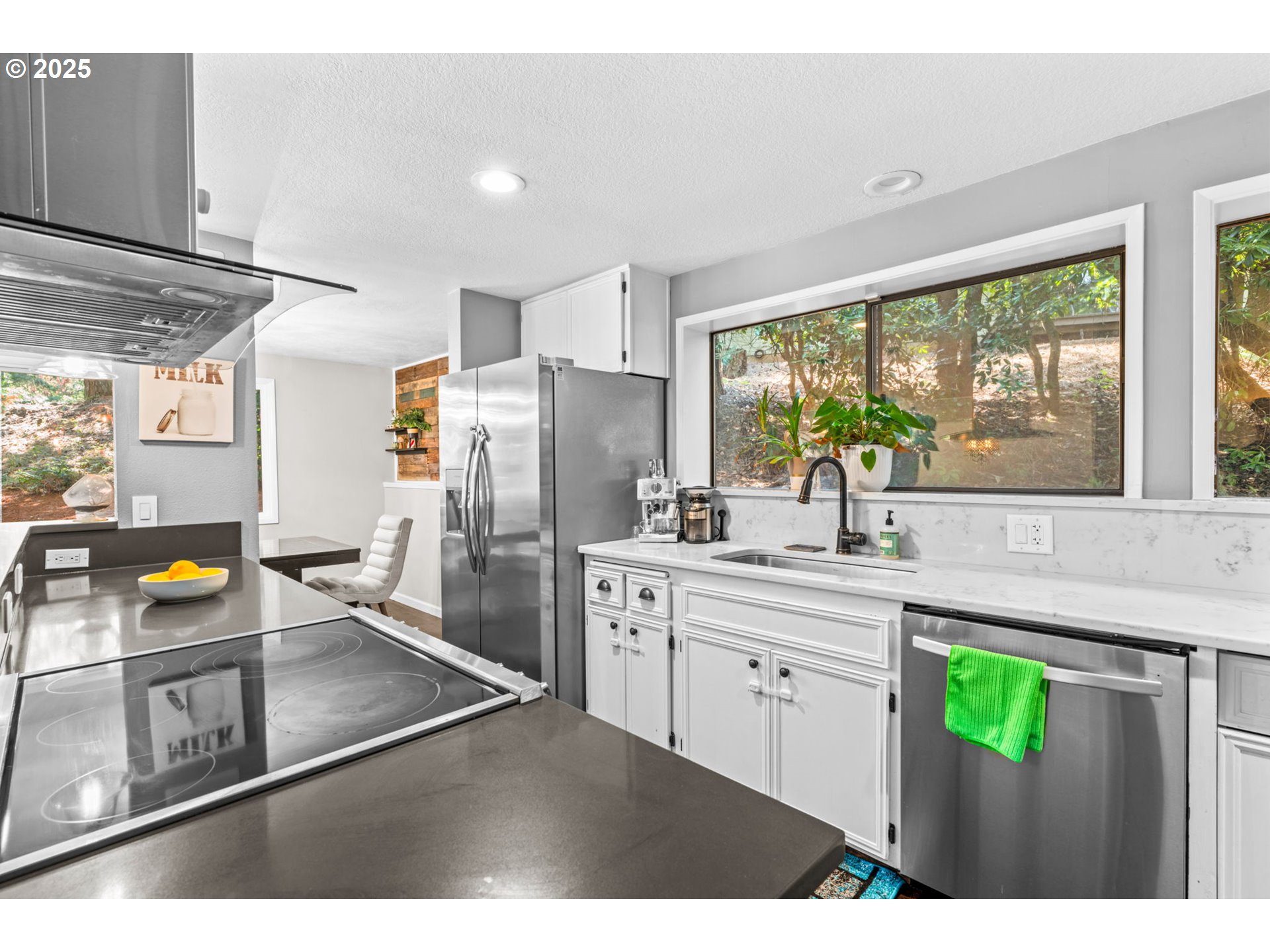 792 Brookside Drive Eugene, OR 97405 - Photo 19 of 46 a kitchen with stainless steel appliances granite countertop a refrigerator a sink a stove and a refrigerator with wooden floor
