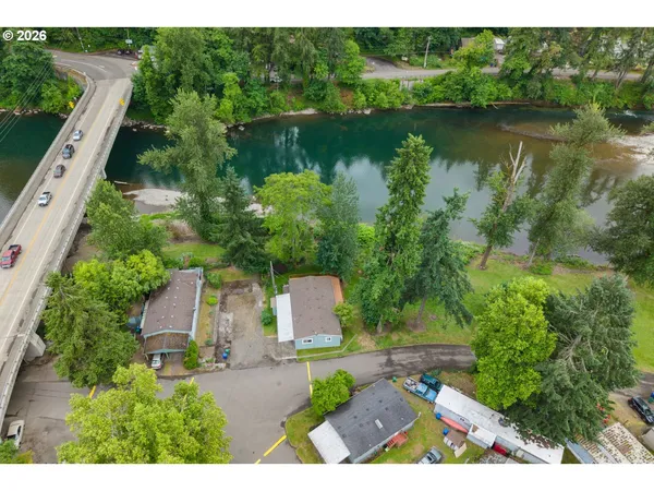 an aerial view of a house with a yard and lake view